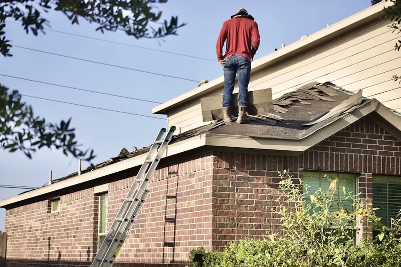 Professional roofer working on a residential roof in Boxwood Farms